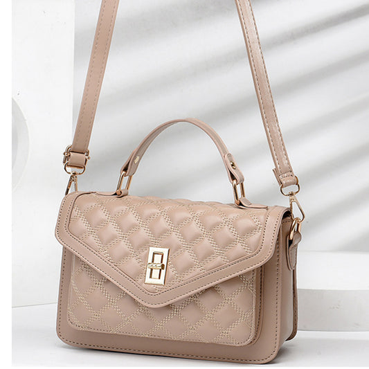 Chic cross design hand bag in black for women.