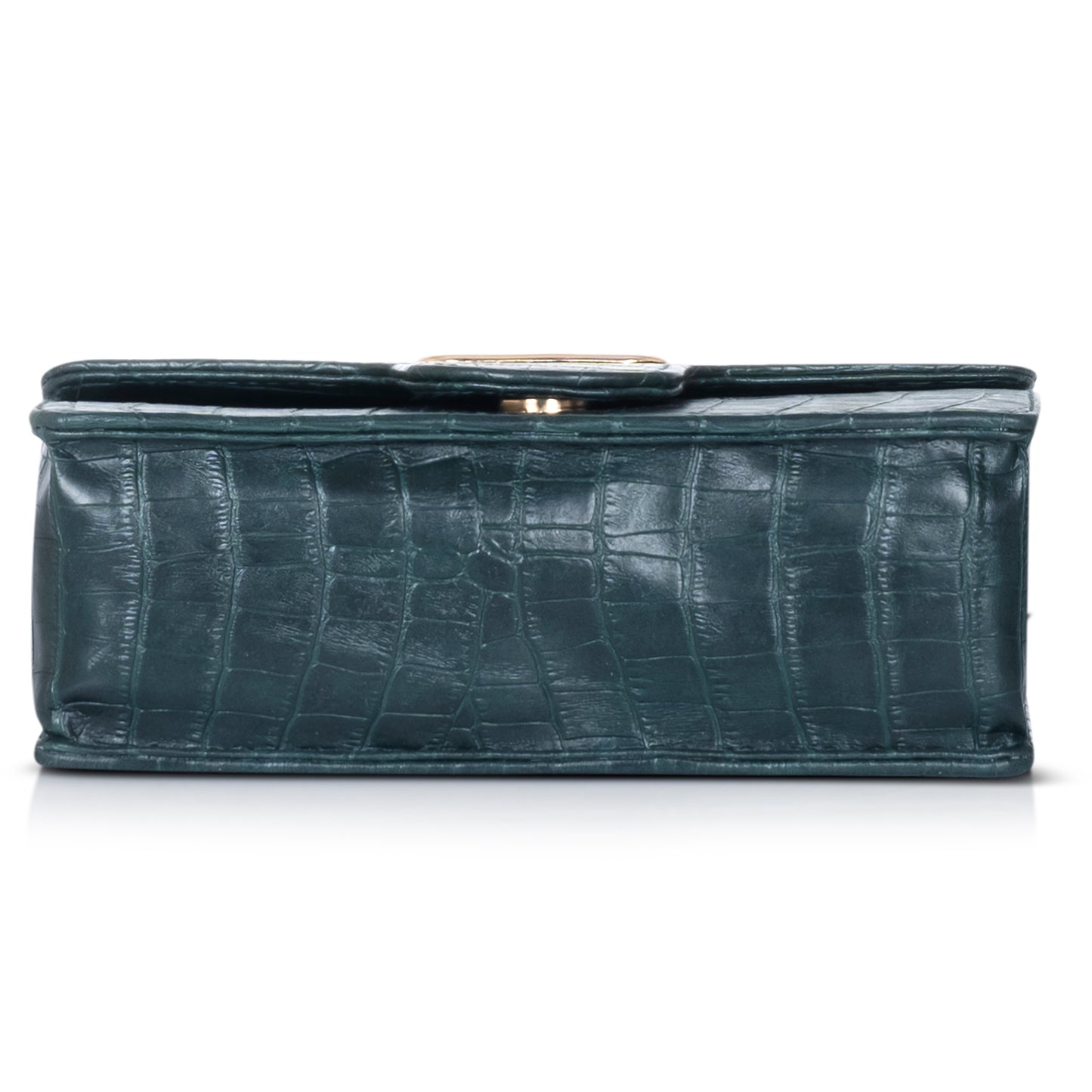 Black crocodile-patterned handbag placed on a marble surface, highlighting its opulent design aesthetic.