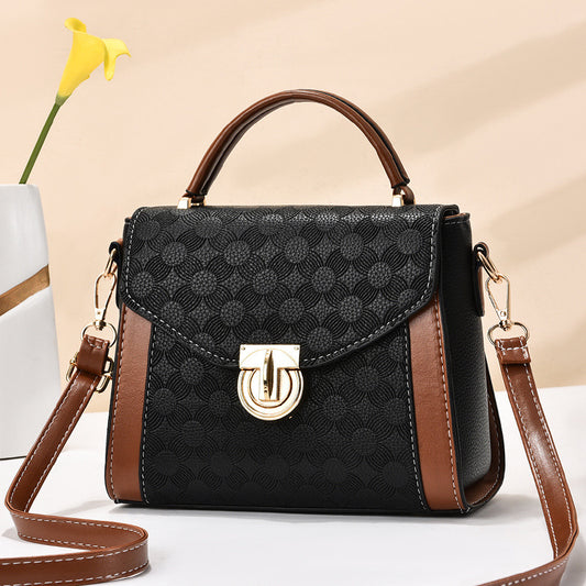 Stylish black sling bag for women with a sleek magnet-open design.