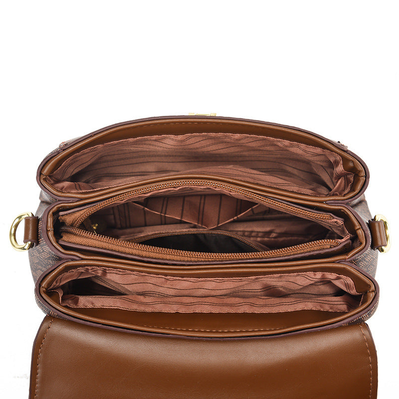 Open Stylish brown sling bag, combining leather and magnet closure charm.