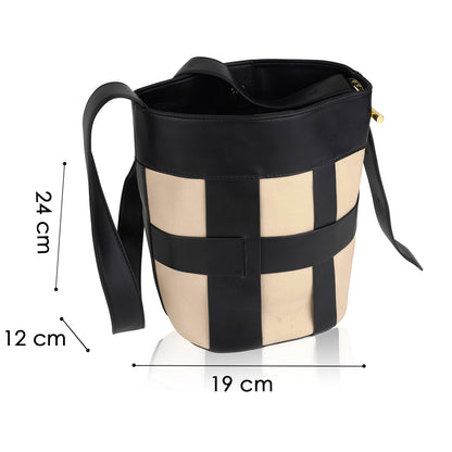 Beige and black bucket canvas handbag with black straps, leather top, and lattice design.