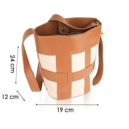 Angeline's brown and cream checked canvas bucket bag with long strap, structured shape, and magnetic closure. Dimensions: 24 cm high, 19 cm wide, 12 cm deep. A stylish and durable handbag for any occasion.