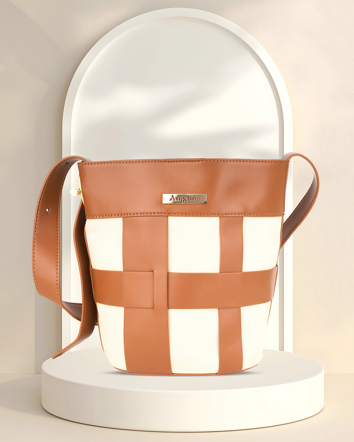 Stylish brown and white checkered canvas bucket bag featuring a durable brown leather strap and gold-colored metal accents, perfect for ladies seeking a trendy and durable handbag for any occasion.